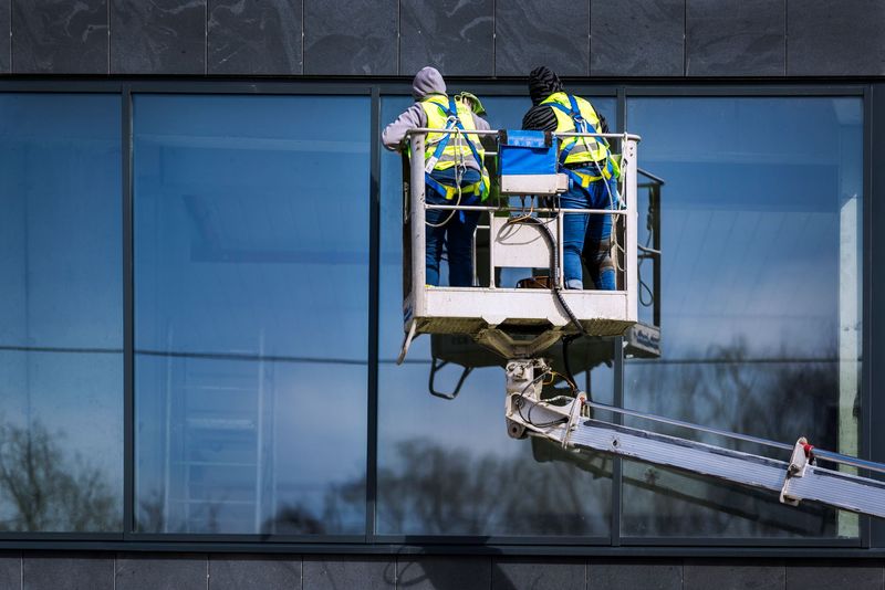 Pressure washing professional cleaning a commercial concrete walkway
